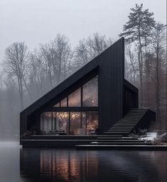 a house that is on the water with stairs leading up to it's roof