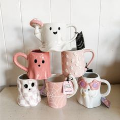 a group of coffee mugs sitting on top of a table next to each other