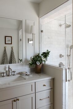 a bathroom with a sink, mirror and bathtub next to a walk in shower