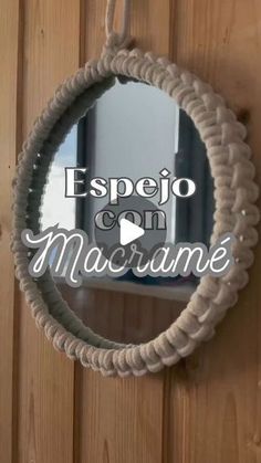 a mirror hanging on the side of a wooden door with words above it that reads espejo con macrame