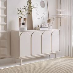 a white cabinet with plants and vases on it in a room that has beige carpeting