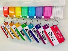 the name tags are attached to different colors of luggage bags and suitcases, which can be used as keychains or lanyards