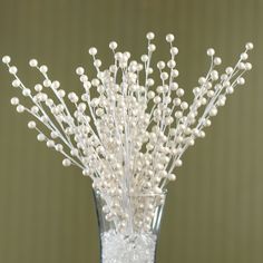 a vase filled with white flowers on top of a table