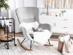 a grey rocking chair in a white living room