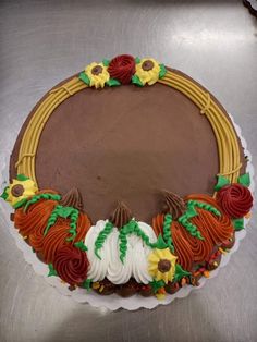 a chocolate cake decorated with flowers and leaves