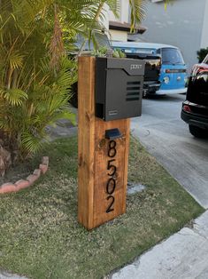 a mailbox sitting in the grass next to a tree