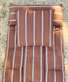 a brown and white striped comforter on the ground