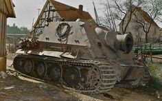 an old tank sitting in front of a house