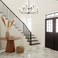 a foyer with stairs and a table in it