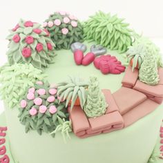 a cake decorated with pink and green decorations