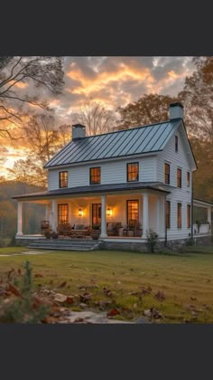 a white house sitting on top of a lush green field