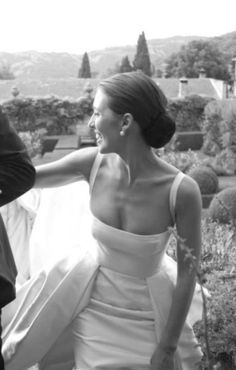 a woman in a white dress sitting next to a man