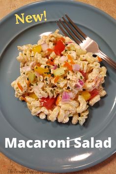 a blue plate topped with macaroni salad next to a fork