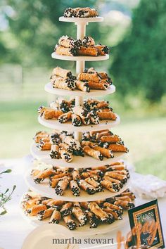 there is a tall tower that has donuts on it and other pastries in the bottom tier