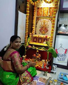 a woman sitting in front of a shrine