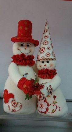 two snowmen are standing next to each other