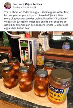 several jars of pickles are sitting on a counter