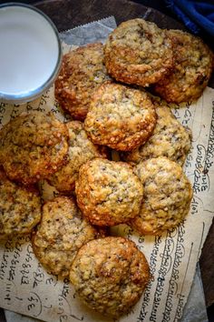 oatmeal cookies and a glass of milk on a piece of parchment paper