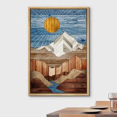 a painting hanging on the wall next to a wooden table with glasses and water in front of it