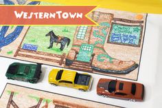 there are cars and trucks that are on the paper with words western town written above them