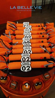 an orange table topped with lots of orange candy bars and candies on top of each other