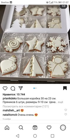 an open box of decorated cookies on top of a table