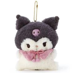 a small stuffed animal with a pink bow around it's neck and eyes, sitting on a white surface