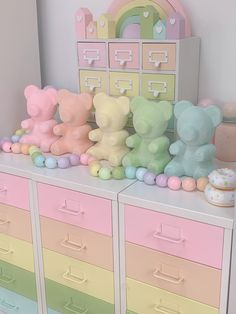 there are many different colored teddy bears on top of the dressers in this child's room