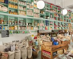 a store filled with lots of different types of food and bags on the shelves next to each other