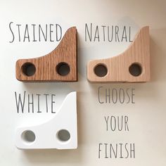 two wooden pegs are attached to the wall with words written on them that read, stained natural, white, choose your finish