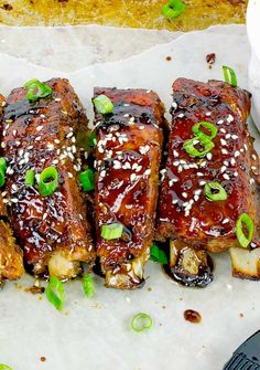 ribs covered in bbq sauce and garnished with green onions