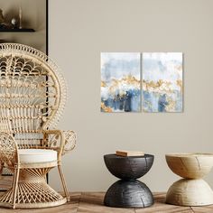 a living room with wicker furniture and two paintings on the wall, one is blue and gold