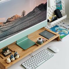 a desktop computer sitting on top of a wooden desk next to a keyboard and mouse