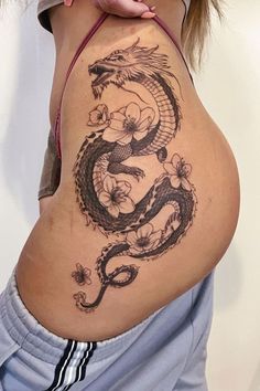 a woman with a dragon tattoo on her stomach