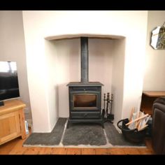 a living room with a wood stove in it