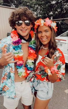 two people dressed in colorful clothing posing for the camera