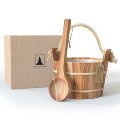 a wooden bucket and spoon next to a cardboard box