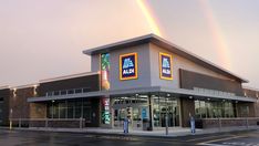 a store with a double rainbow in the background