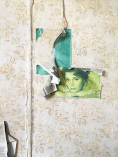 a piece of torn paper hanging from a wall