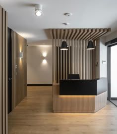 an empty office with wood paneling and lighting