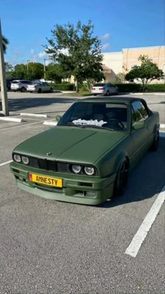 a green car parked in a parking lot