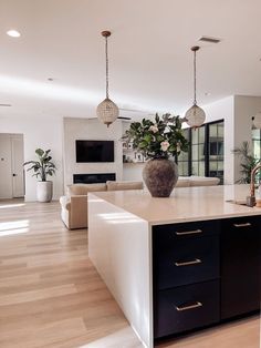 a large kitchen with an island in the middle and lots of counter space on each side