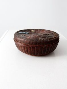 a brown basket sitting on top of a white table