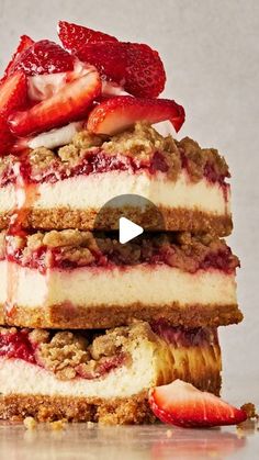 three layered desserts stacked on top of each other with strawberries in the middle