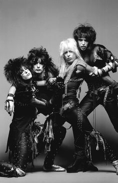 the band kiss posing for a black and white photo in front of a gray background