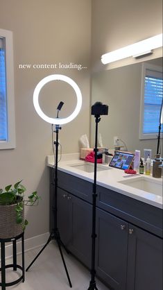 a photo studio setup up in a bathroom with the lights on and an open laptop next to it