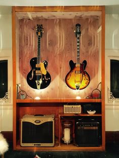 guitars and amps are on display in a room