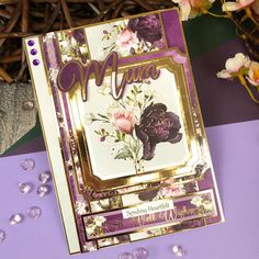 a close up of a greeting card on a table next to flowers and other items