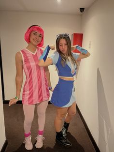 two women dressed in costumes standing next to each other