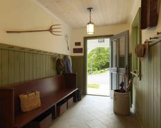 a wooden bench sitting in the middle of a hallway next to a door and window